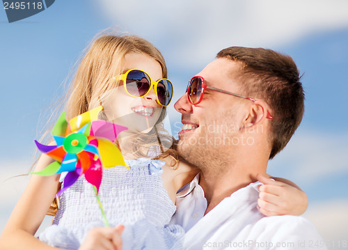 Image of happy father and child in sunglasses over blue sky