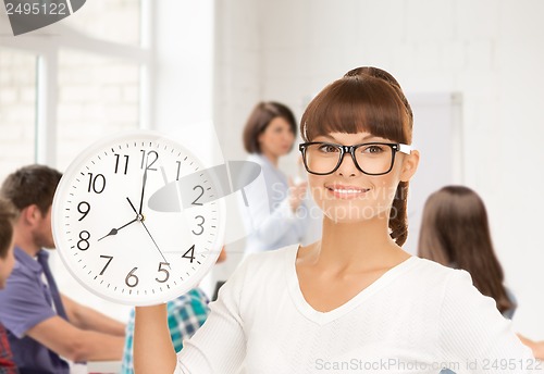 Image of student showing clock