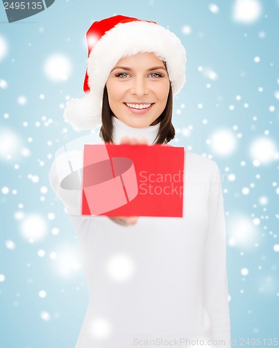 Image of woman in santa helper hat with blank red card