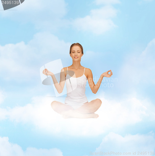 Image of girl sitting in lotus position and meditating