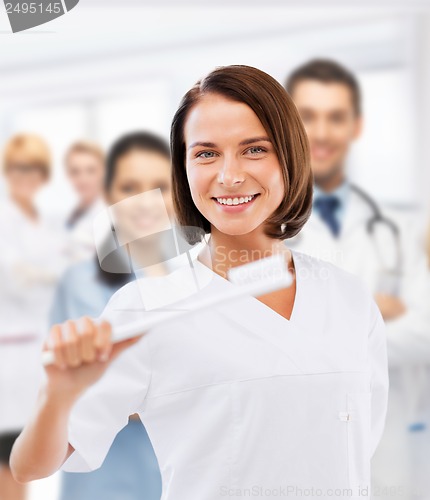 Image of dentist with toothbrush in hospital