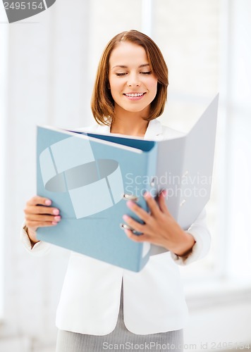 Image of businesswoman with folders in office