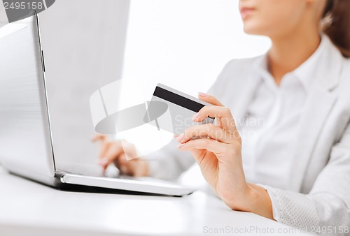 Image of businesswoman with laptop and credit card