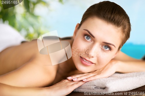 Image of woman in spa salon with hot stones