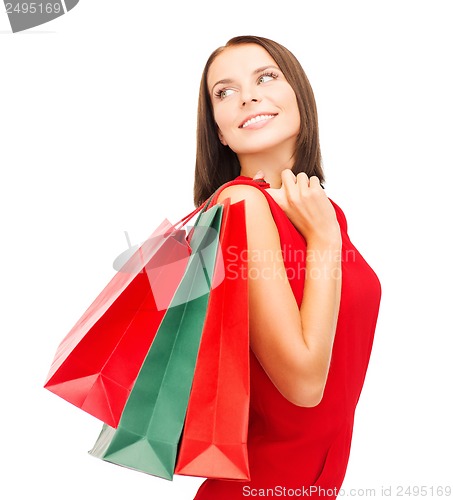 Image of woman in red dress with shopping bags