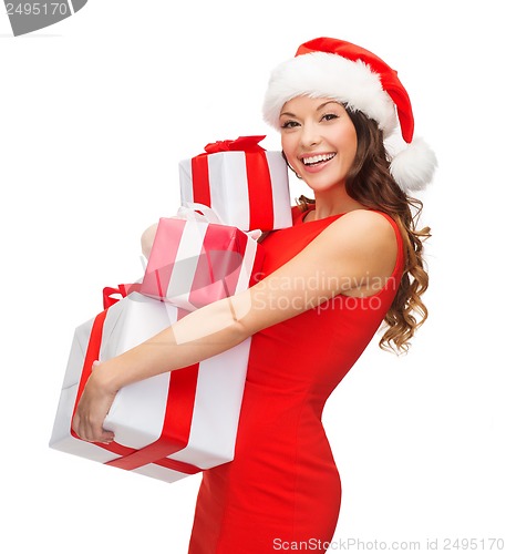 Image of woman in santa helper hat with many gift boxes