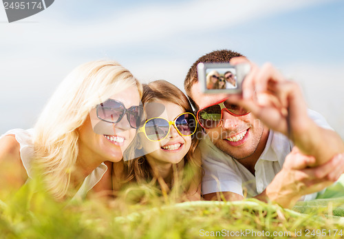 Image of happy family with camera taking picture