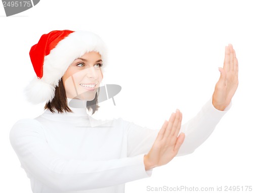 Image of smiling woman in santa helper hat