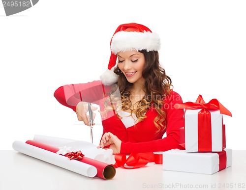 Image of smiling woman in santa helper hat with gift box