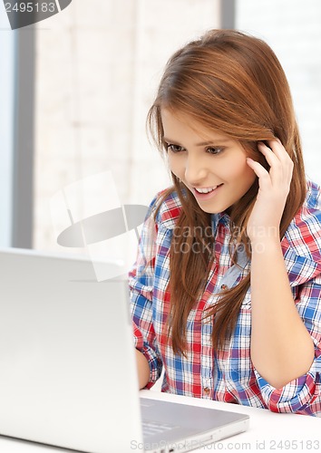 Image of smiling student girl with laptop at school