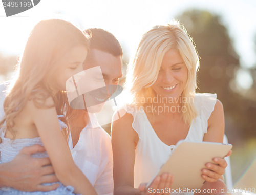 Image of happy family with tablet pc taking picture