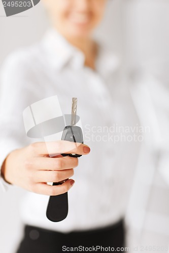 Image of woman hand holding car key