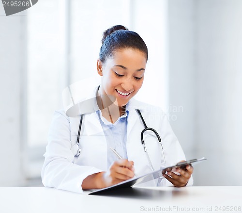 Image of female doctor writing prescription