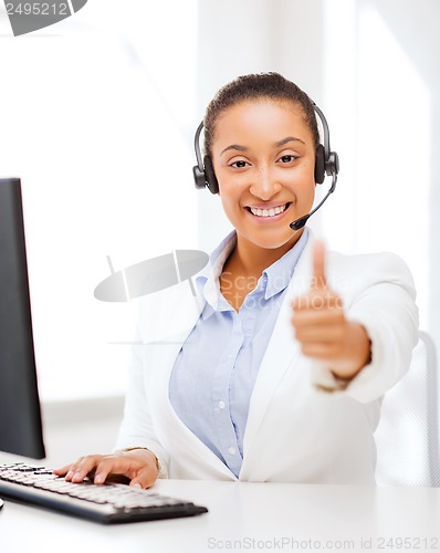 Image of african female helpline operator showing thumbs up