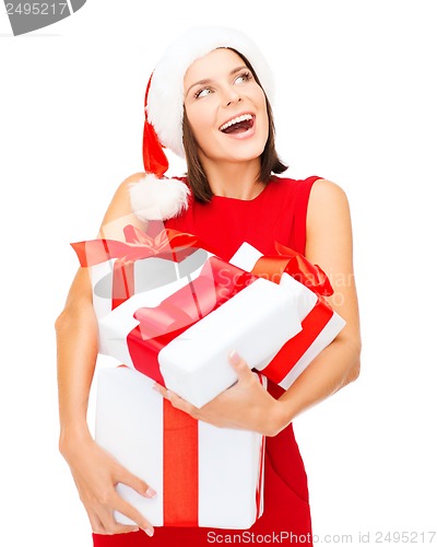 Image of woman in santa helper hat with many gift boxes