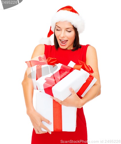 Image of woman in santa helper hat with many gift boxes