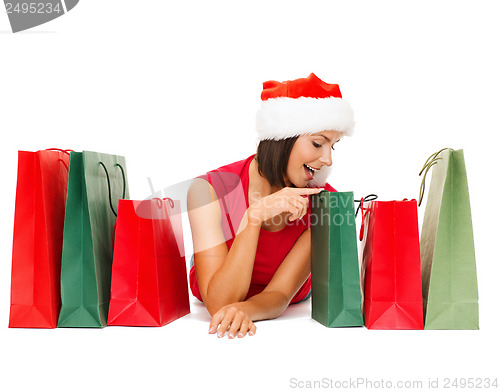 Image of woman in red shirt with shopping bags