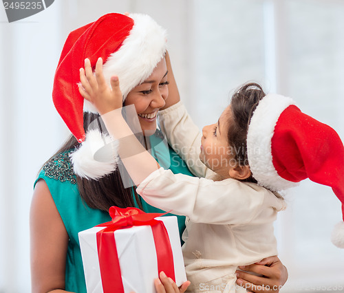 Image of happy mother and child girl with gift box