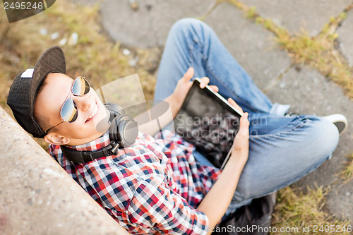 Image of girl with headphones and tablet pc