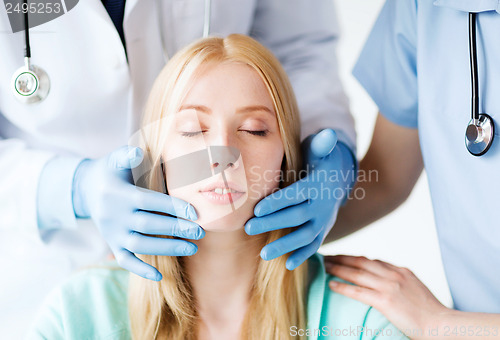 Image of plastic surgeon or doctor with patient