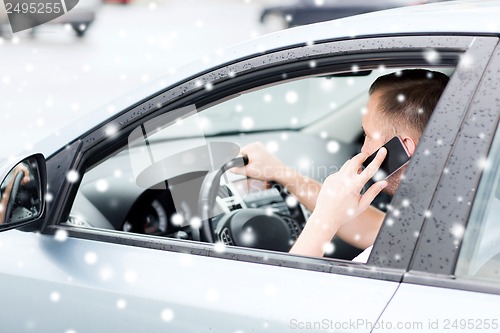 Image of man using phone while driving the car