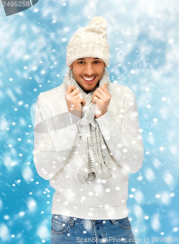 Image of handsome man in warm sweater, hat and scarf