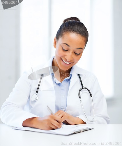 Image of female doctor writing prescription