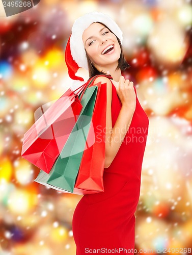 Image of woman in red dress with shopping bags