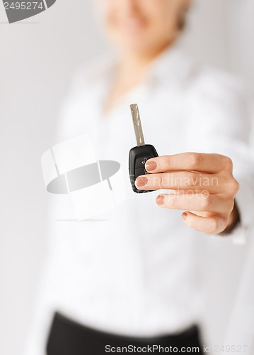 Image of woman hand holding car key