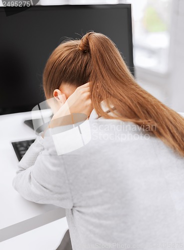 Image of stressed woman with computer