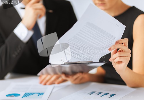 Image of man and woman signing contract paper