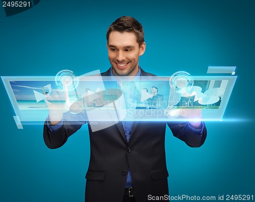 Image of businessman pressing buttons on virtual screen