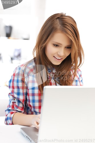 Image of smiling student girl with laptop at school