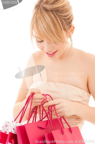 Image of happy woman with many shopping bags