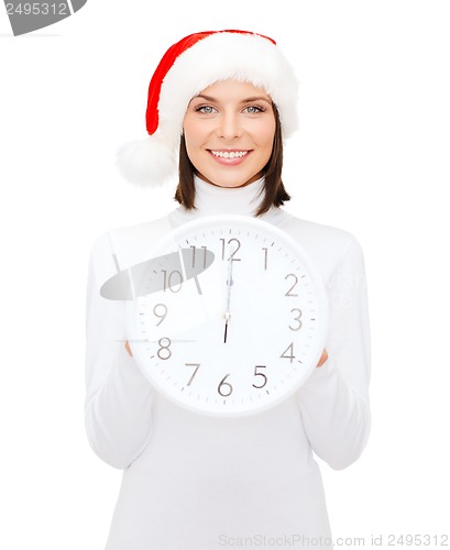 Image of woman in santa helper hat with clock showing 12