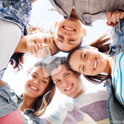 Image of group of teenagers looking down