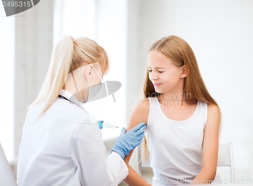 Image of doctor doing vaccine to child in hospital