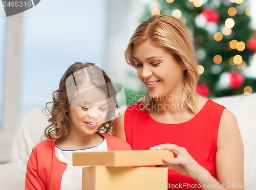 Image of happy mother and child girl with gift box