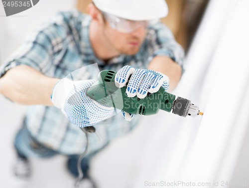 Image of man drilling the wall