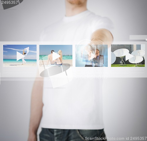 Image of man pressing button on virtual screen