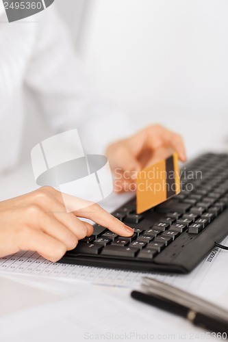 Image of businesswoman with laptop using credit card