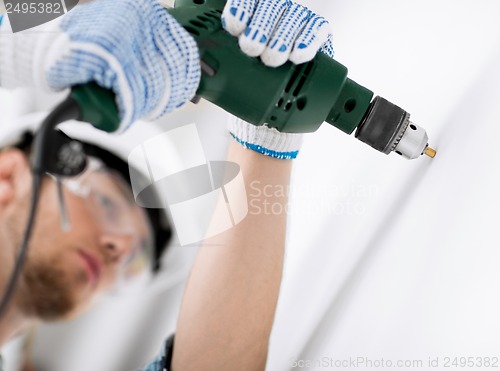 Image of man drilling the wall