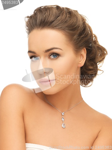 Image of woman wearing shiny diamond pendant