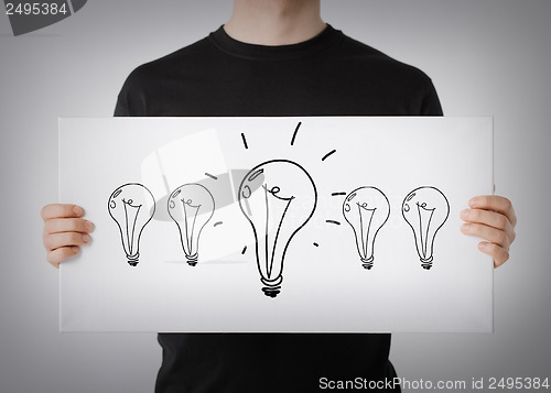 Image of man showing picture with light bulbs