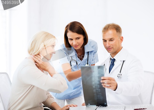 Image of doctors with patient looking at x-ray