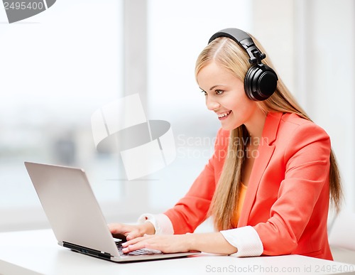 Image of happy woman with headphones listening to music