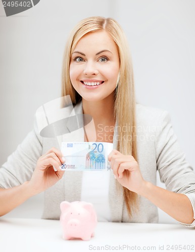 Image of woman with piggy bank and cash money