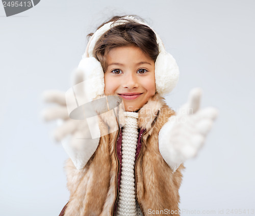 Image of happy littl girl in winter clothes