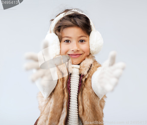 Image of happy littl girl in winter clothes