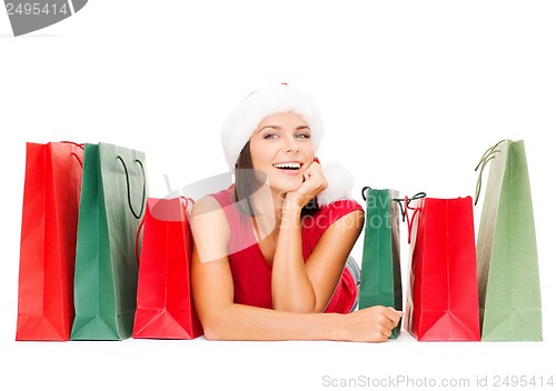 Image of woman in red shirt with shopping bags